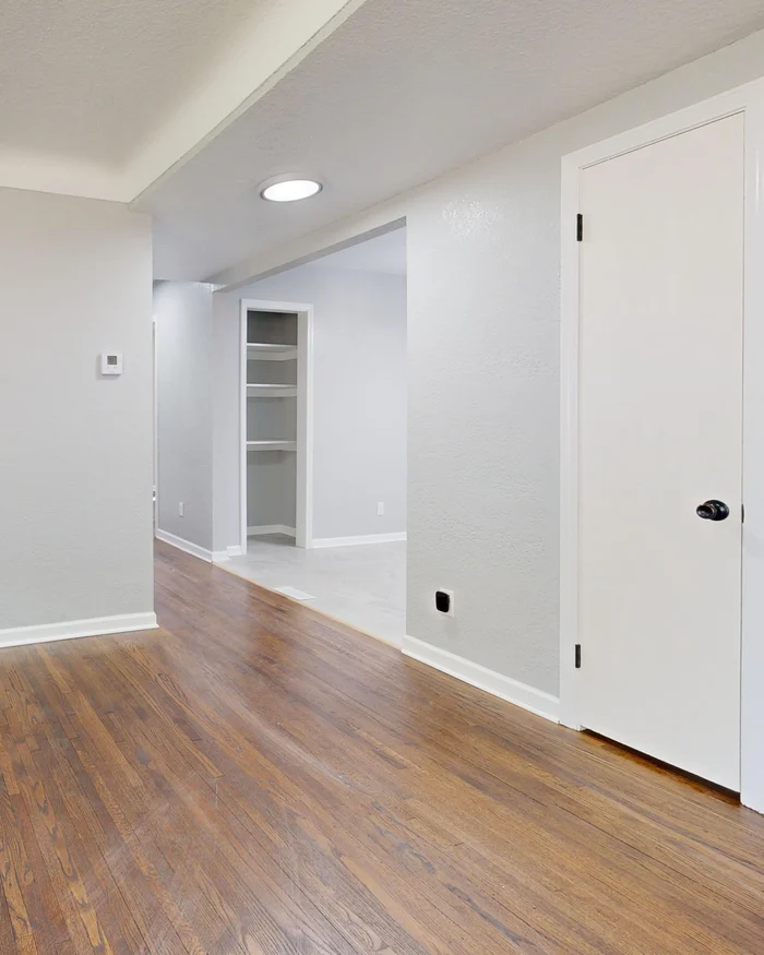 Freshly painted room with a flat white ceiling, white door casing and crisp baseboards